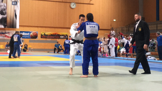 Photo of Anthony Ferraro (in blue) competing in a Judo match in Germany.