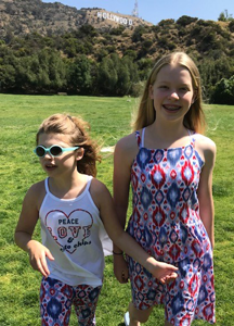Photo of the Reichardt sisters in a park under the Hollywood sign.