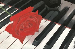 Bright red rose contrasting with the black and white piano keys.