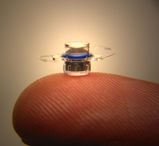 Photo of the Implantable Minature Telescope on a fingertip