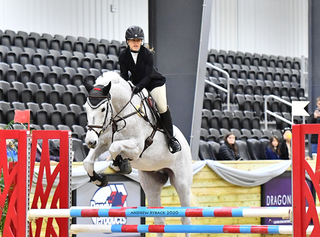 Wren Blae Zimmerman jumping her horse, Cassicasca during an equestrian event.